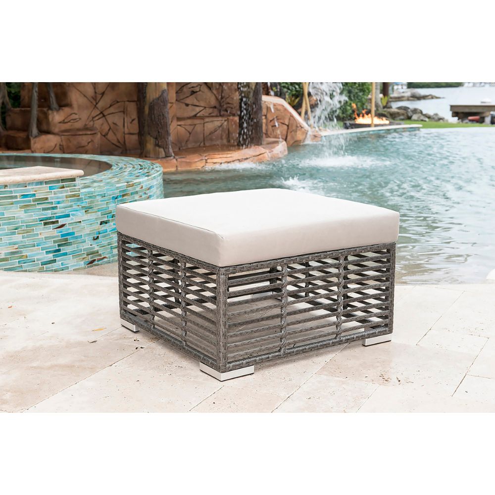 Outdoor ottoman with white cushion near a pool