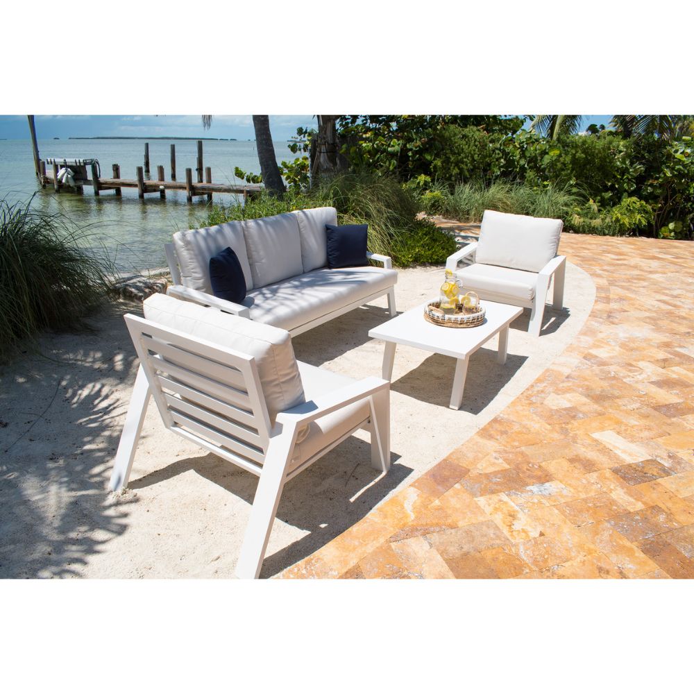 Outdoor patio set with chairs and a table by a waterfront