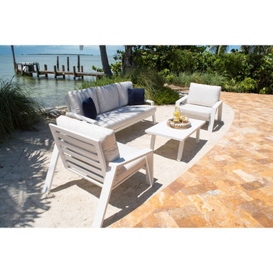 Outdoor patio set with chairs and a table by a waterfront