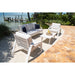 Outdoor patio set with chairs and a table by a waterfront