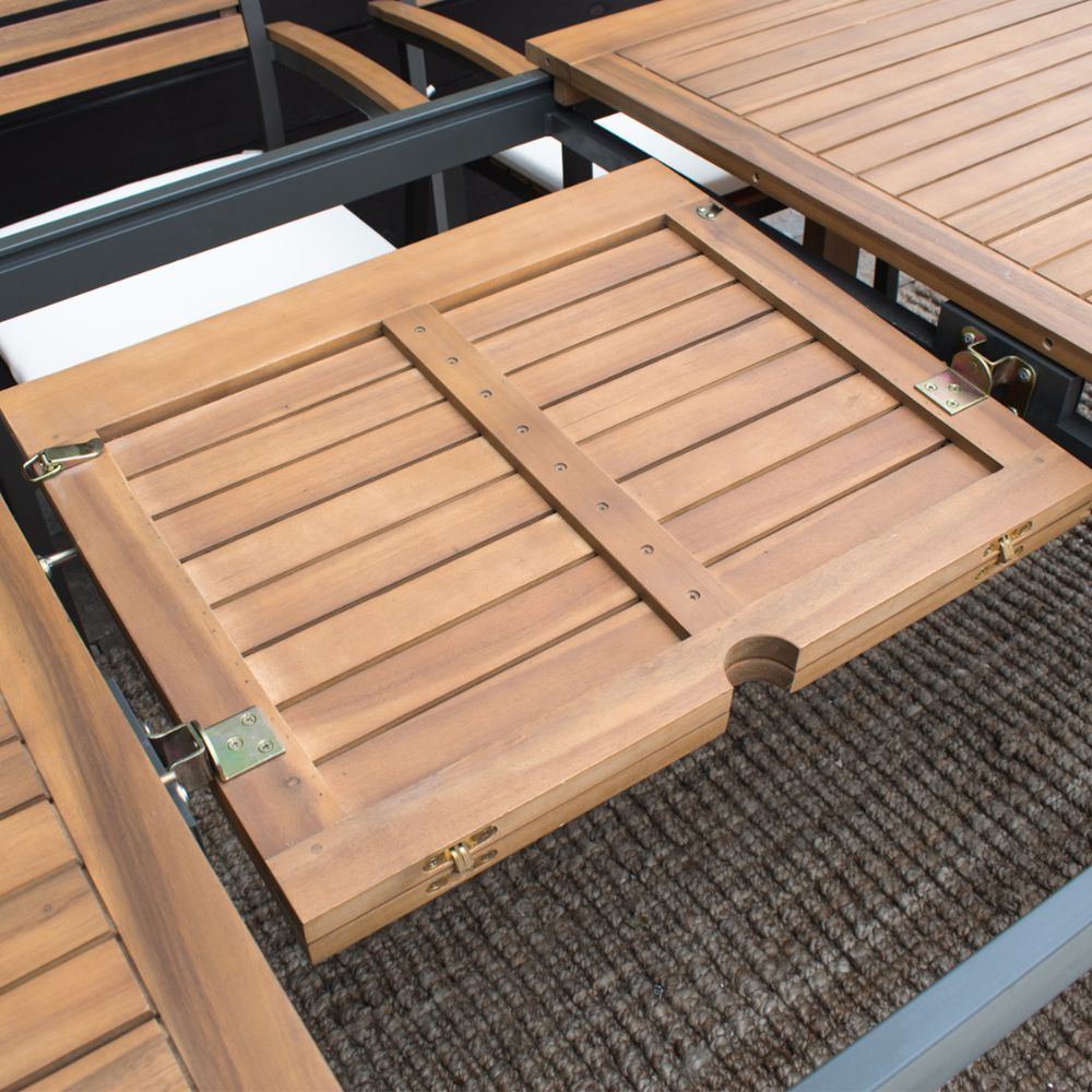 Wooden outdoor table with a hinged cover on a textured surface