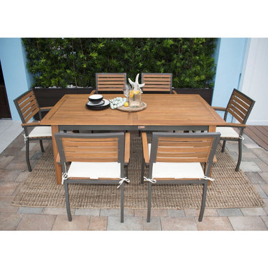 Outdoor dining set with wooden table and chairs on a patio
