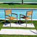 Two wooden chairs by a poolside on a grassy area