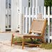 Wooden outdoor chair with woven backrest in a garden setting