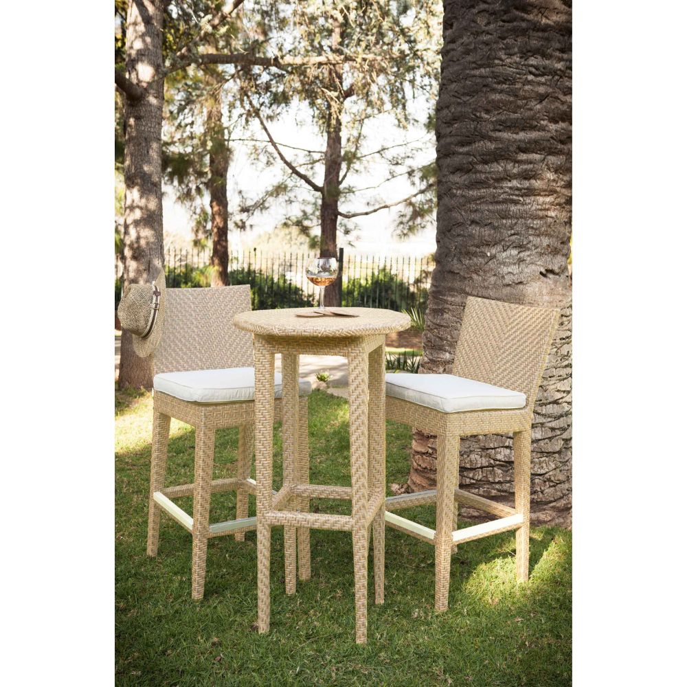 Outdoor patio set with a table and two chairs under a tree