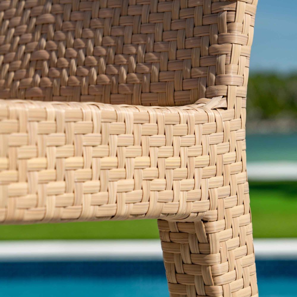 Close-up of woven wicker chair with blurred outdoor background