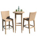 Wicker bar height table with two chairs on a white background