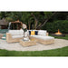 Outdoor patio furniture set with a fire pit and fountain in the background