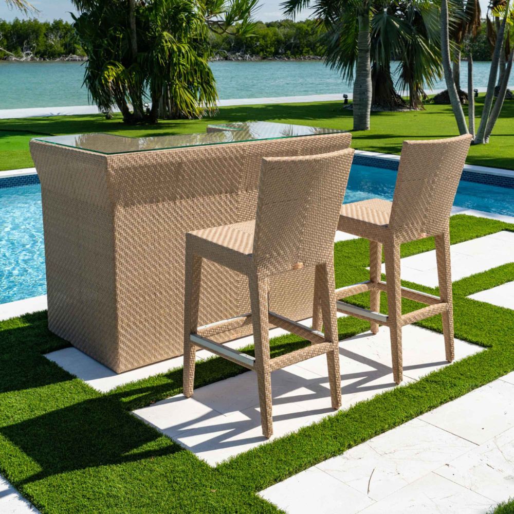 Outdoor patio set with a table and chairs by a poolside