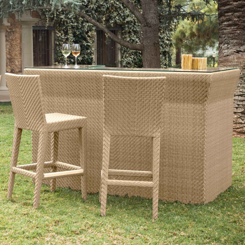Wicker outdoor bar set with stools on a grassy area