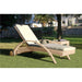 Wicker sun lounger with beige cushion on a grassy area