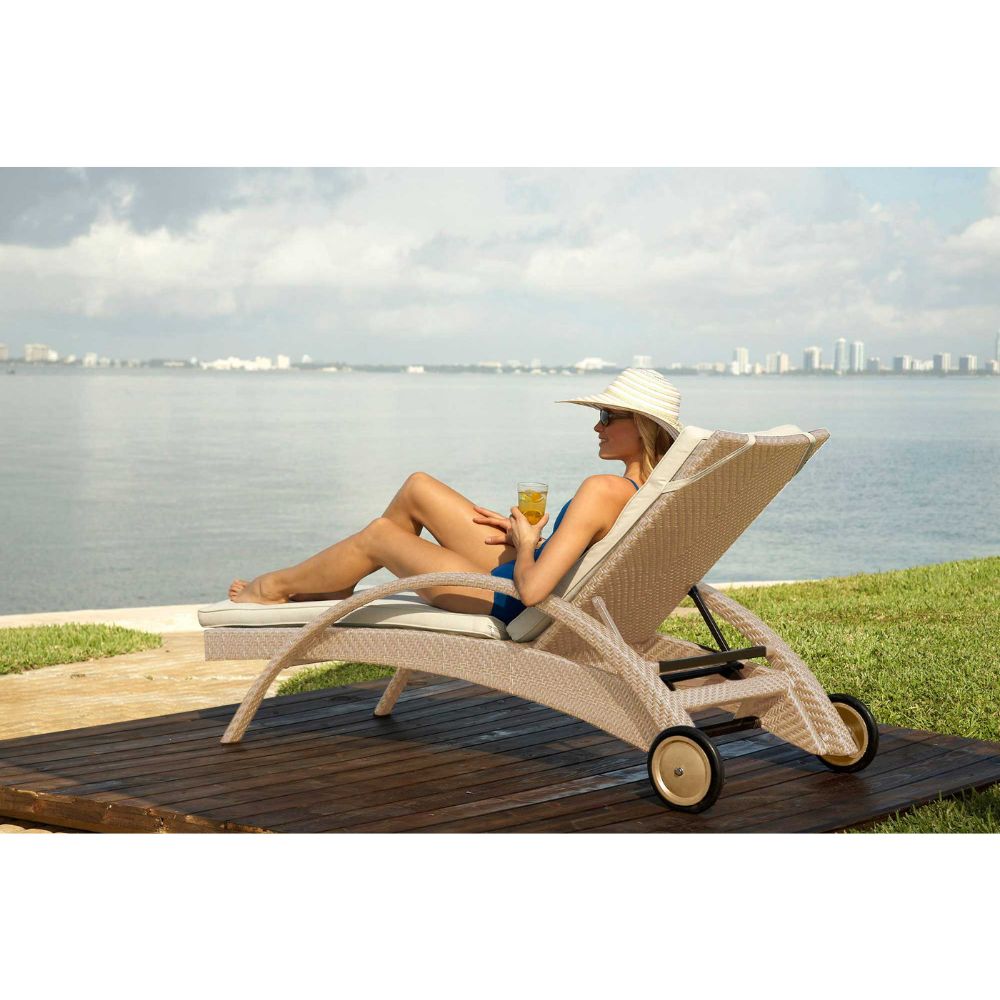 Woman relaxing on a sun lounger by the water