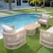 Outdoor patio furniture set with chairs and a table by a pool