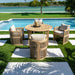 Outdoor patio set with wooden furniture and cushions by a poolside.
