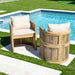 Two wooden chairs with white cushions by a pool