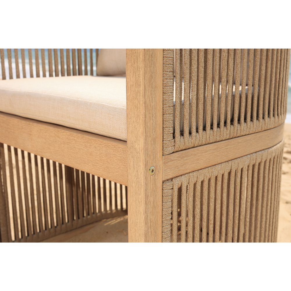 Close-up of a wooden outdoor chair with beige cushion on a blurred background