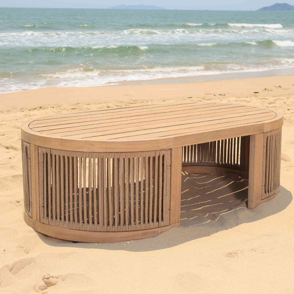 Wooden bench on a sandy beach with ocean waves in the background