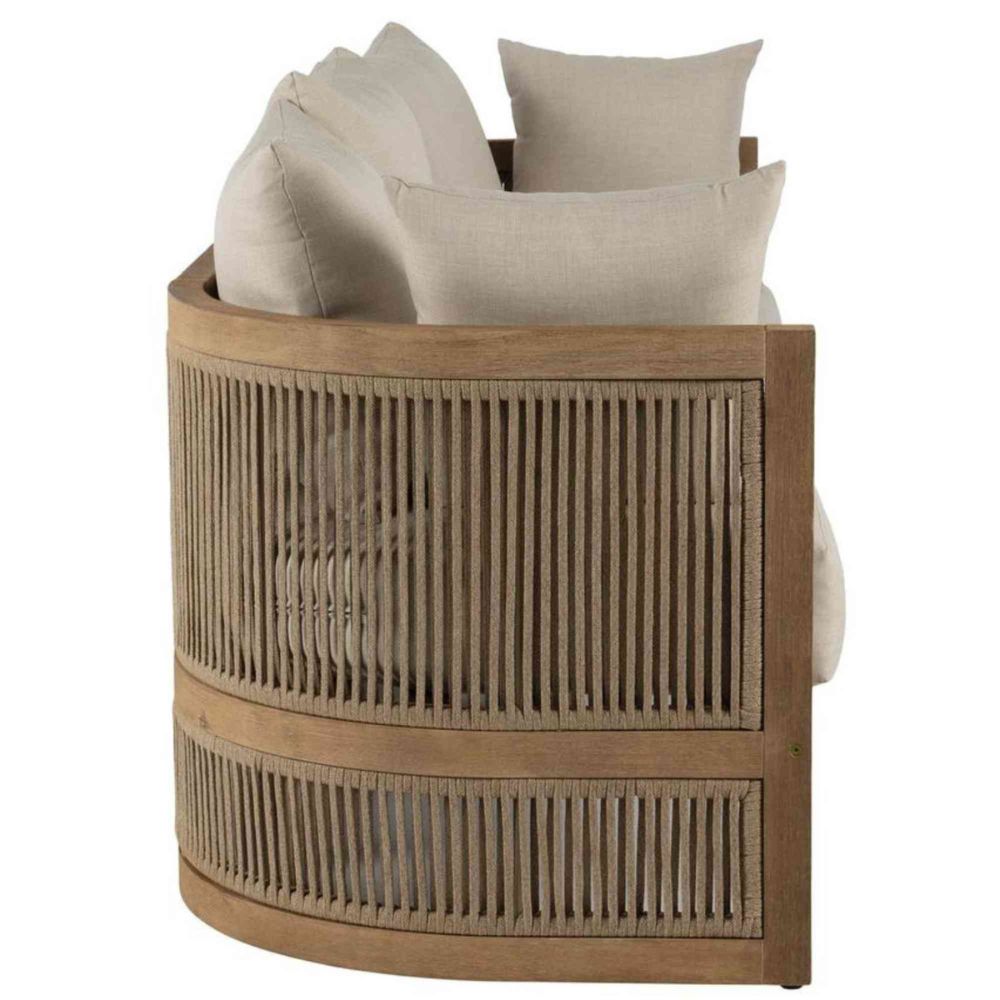 Wooden basket with woven design containing beige pillows on a white background