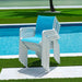 Stacked blue and white chairs by a poolside