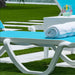 Blue lounge chair with a rolled towel on a grassy area