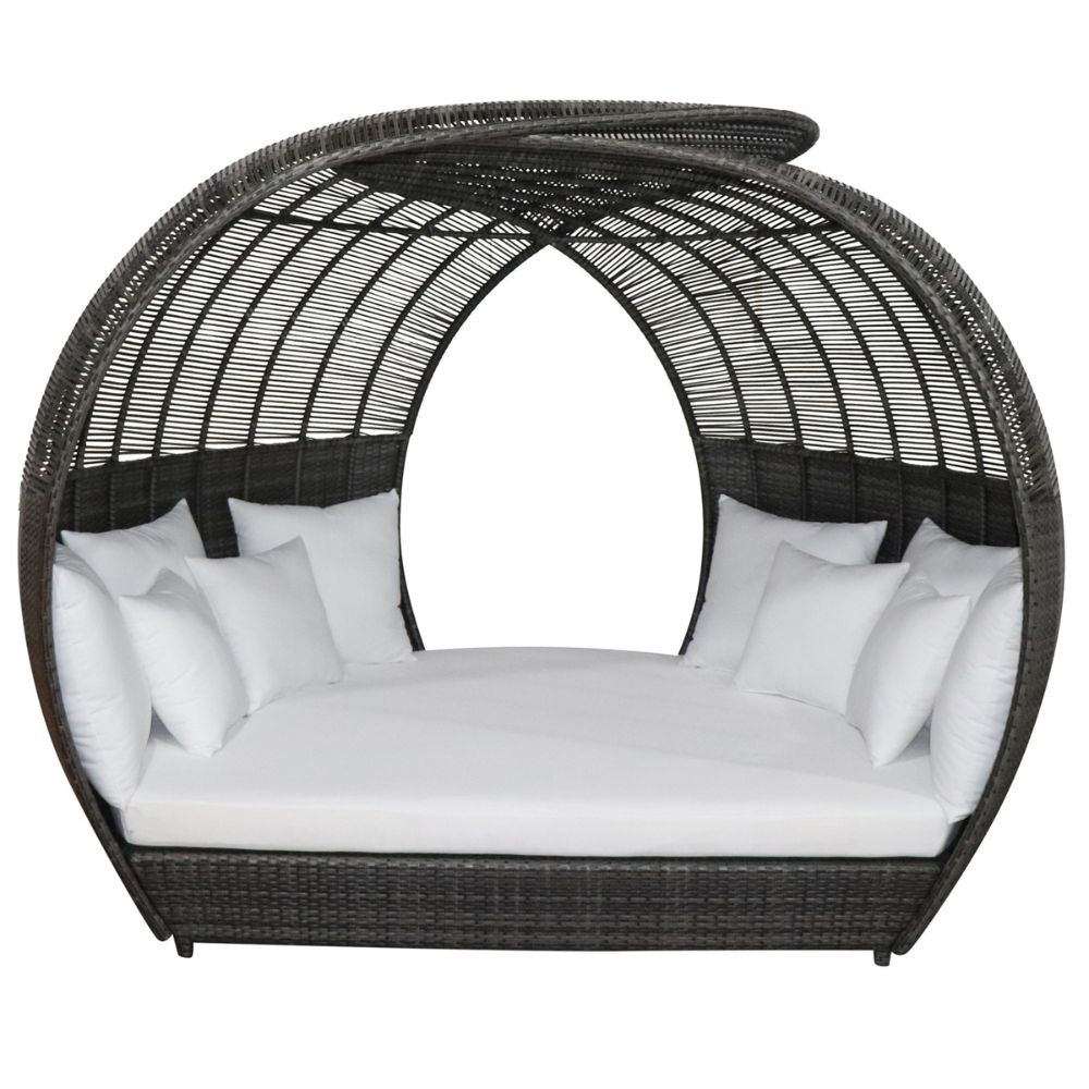 Wicker daybed with white cushions on a white background