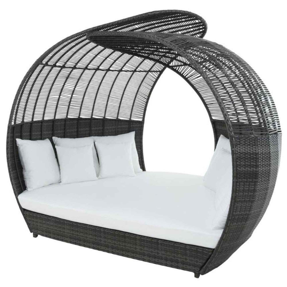 Wicker daybed with white cushions on a white background