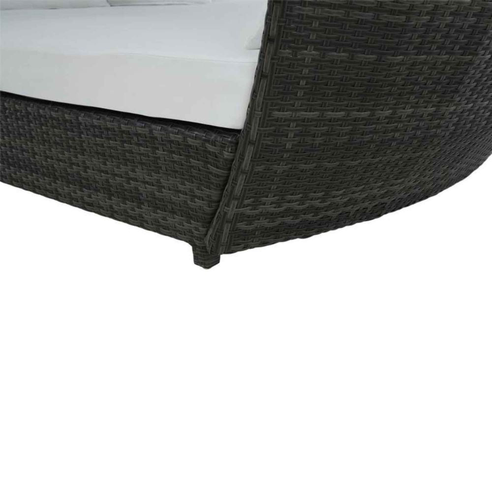 Dark woven outdoor furniture with white cushion on a white background