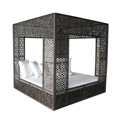 Black woven canopy bed with white bedding on a white background