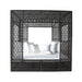 Woven black frame around a bed with white bedding on a white background
