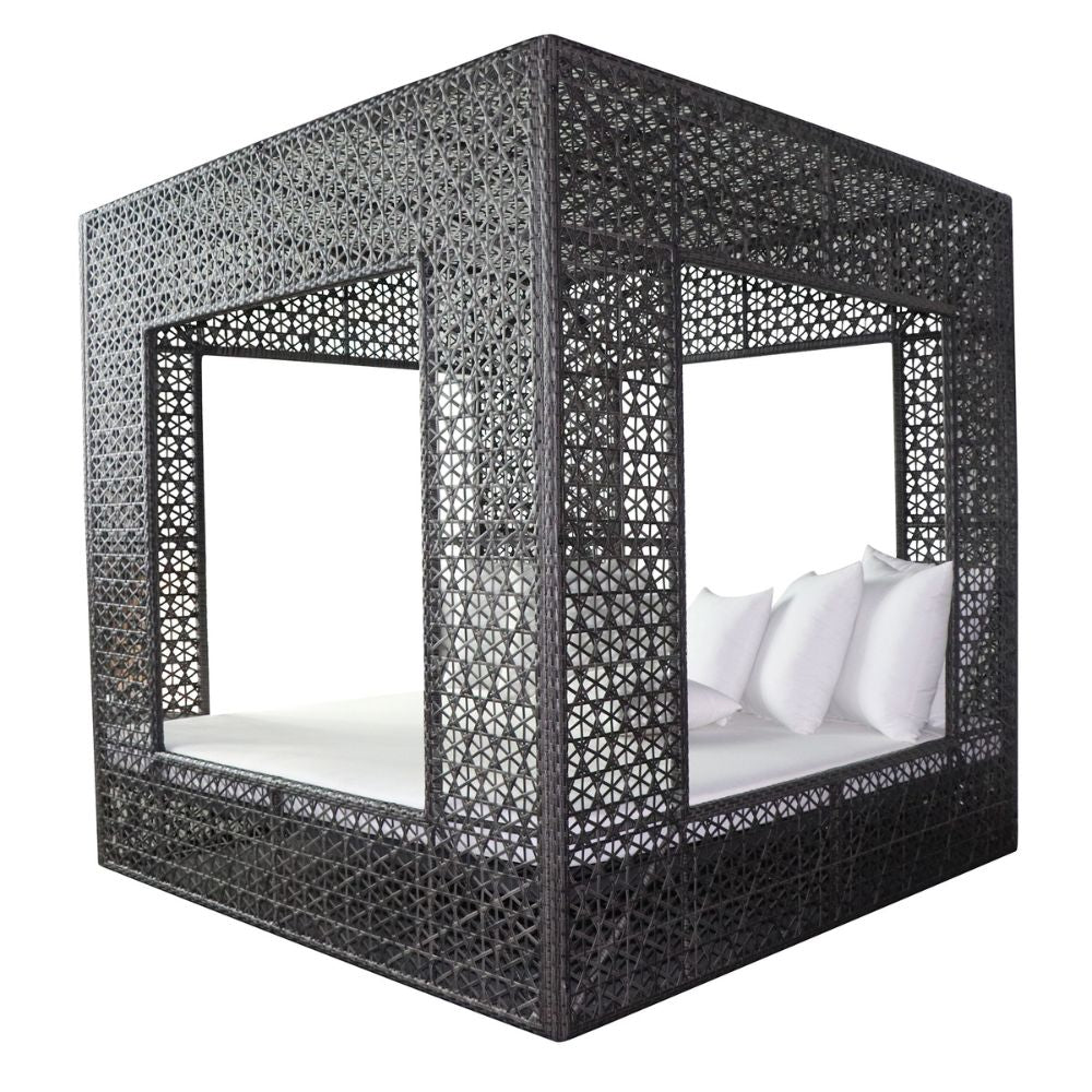 Black woven outdoor bed with white bedding on a white background