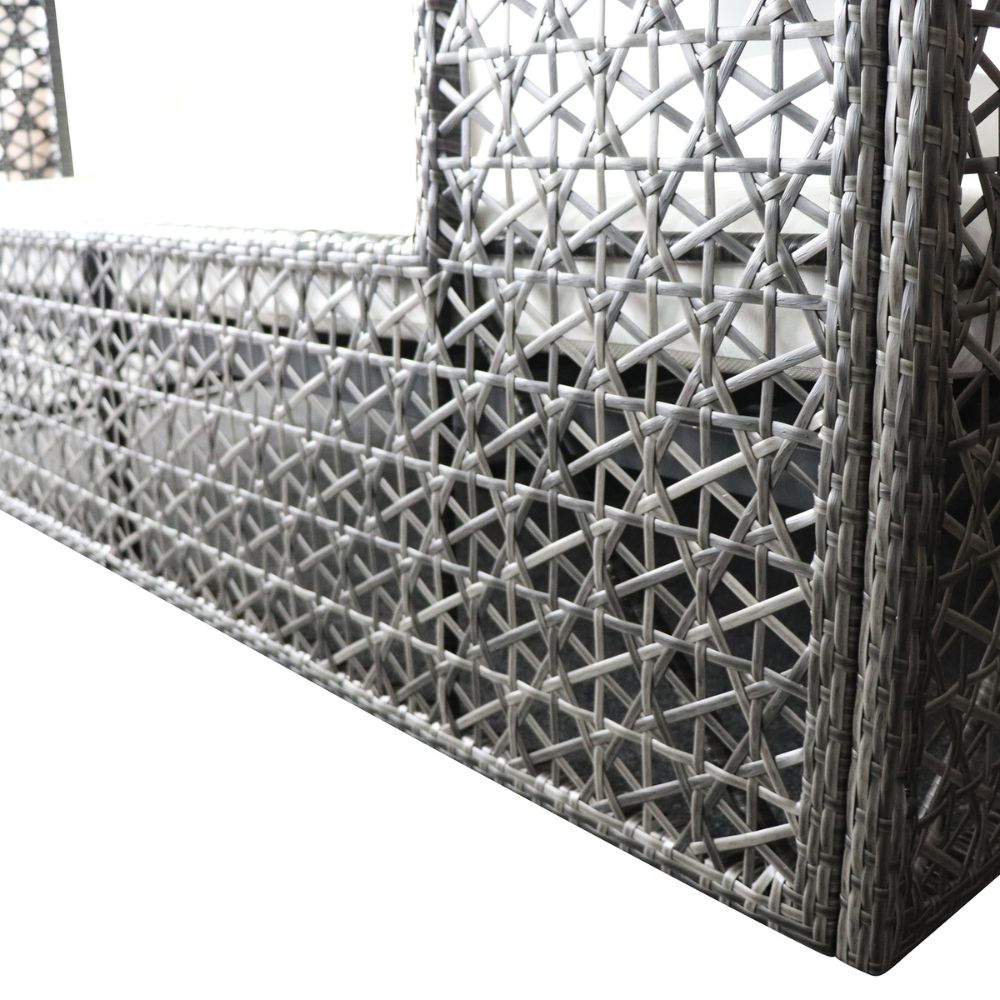 Close-up of a woven metal fence with geometric pattern