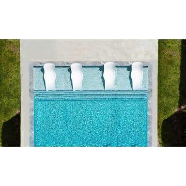 Aerial view of a swimming pool with lounge chairs on a grassy area