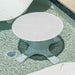 Round white table with textured surface on a pool deck