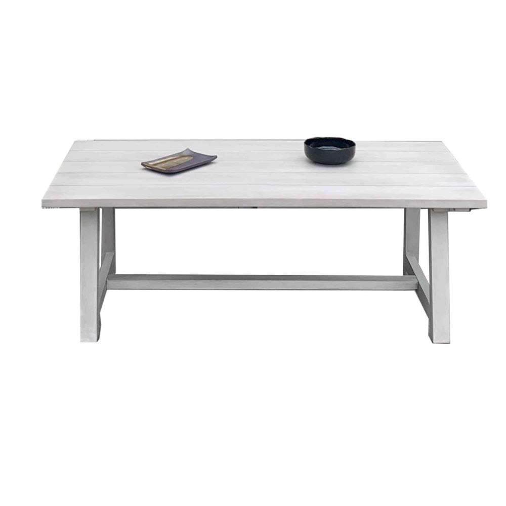 White rectangular table with two black bowls on a white background