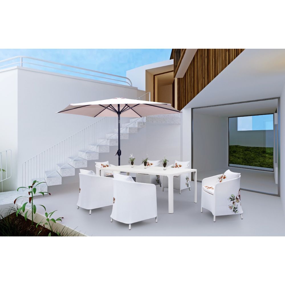 Outdoor patio set with white furniture and a large umbrella on a modern terrace.