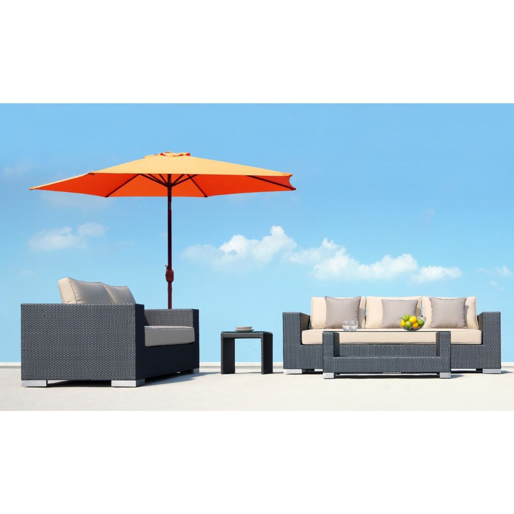 Outdoor furniture set with a sofa, armchair, and table under an orange umbrella against a blue sky.
