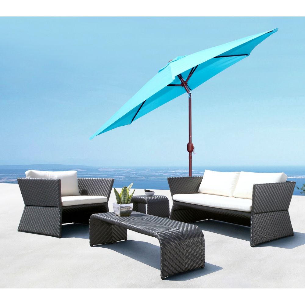 Outdoor patio furniture set with a blue umbrella on a sunny day.