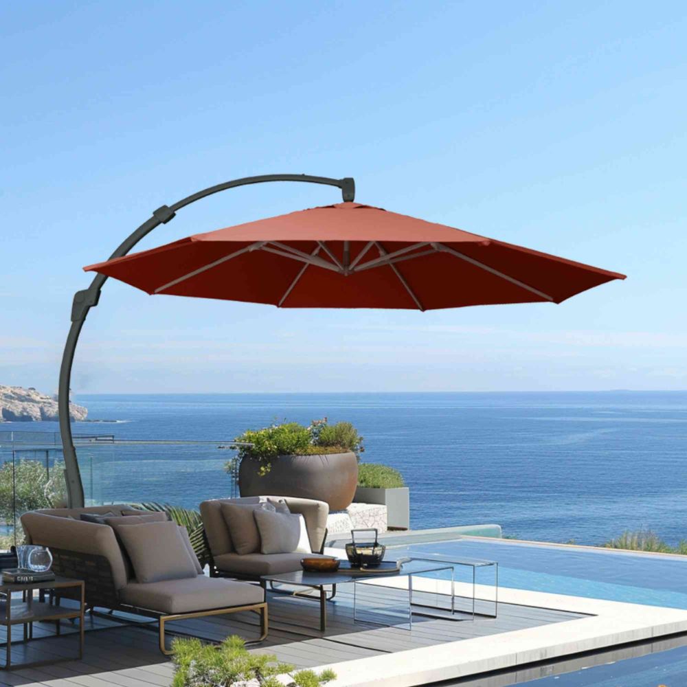Red patio umbrella over outdoor furniture set with ocean view