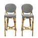Two bamboo bar stools with striped cushions on a white background