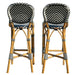 Two bar stools with wicker frames and chevron-patterned seats on a white background