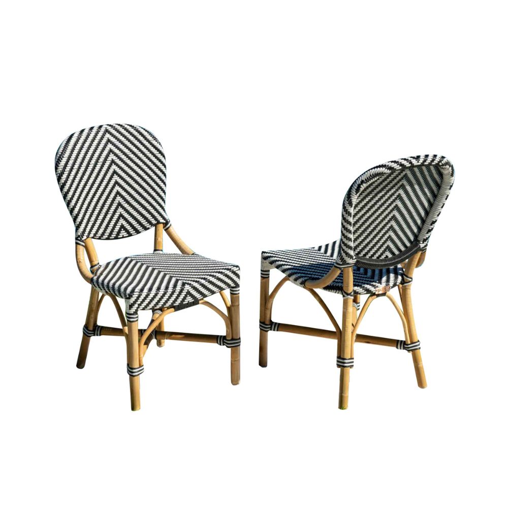 Two wicker chairs with striped cushions on a white background