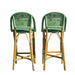 Two green and brown wicker bar stools on a white background