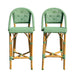 Two green wicker bar stools on a white background