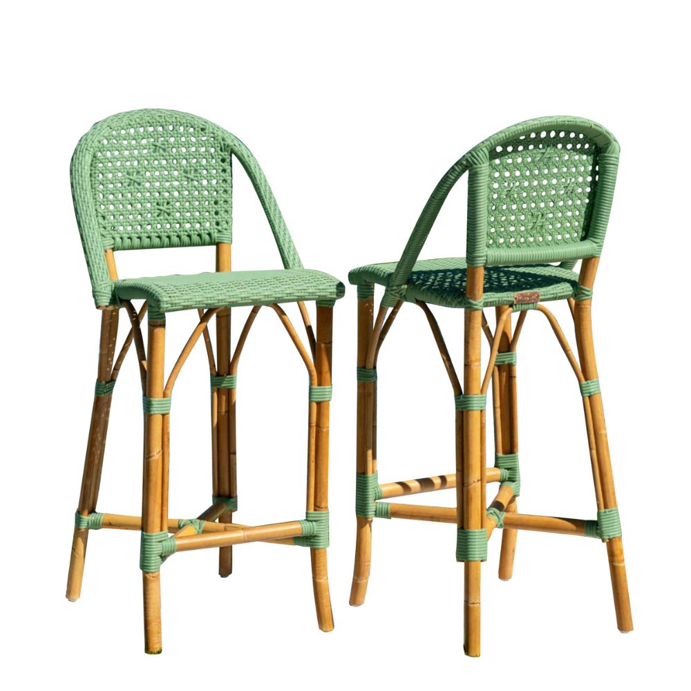 Two green and brown wicker bar stools on a white background