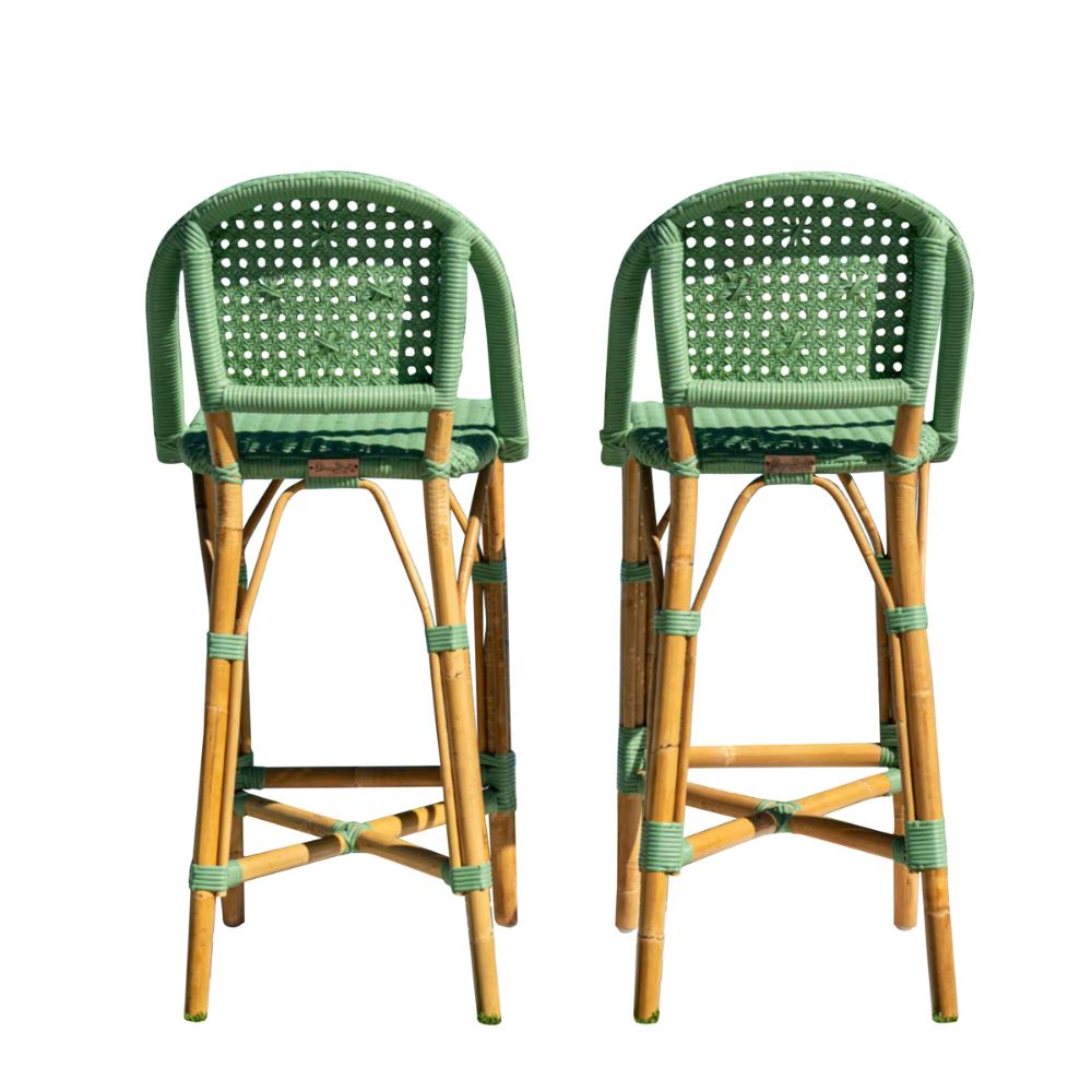 Two green and brown wicker bar stools on a white background