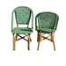 Two green wicker chairs on a white background