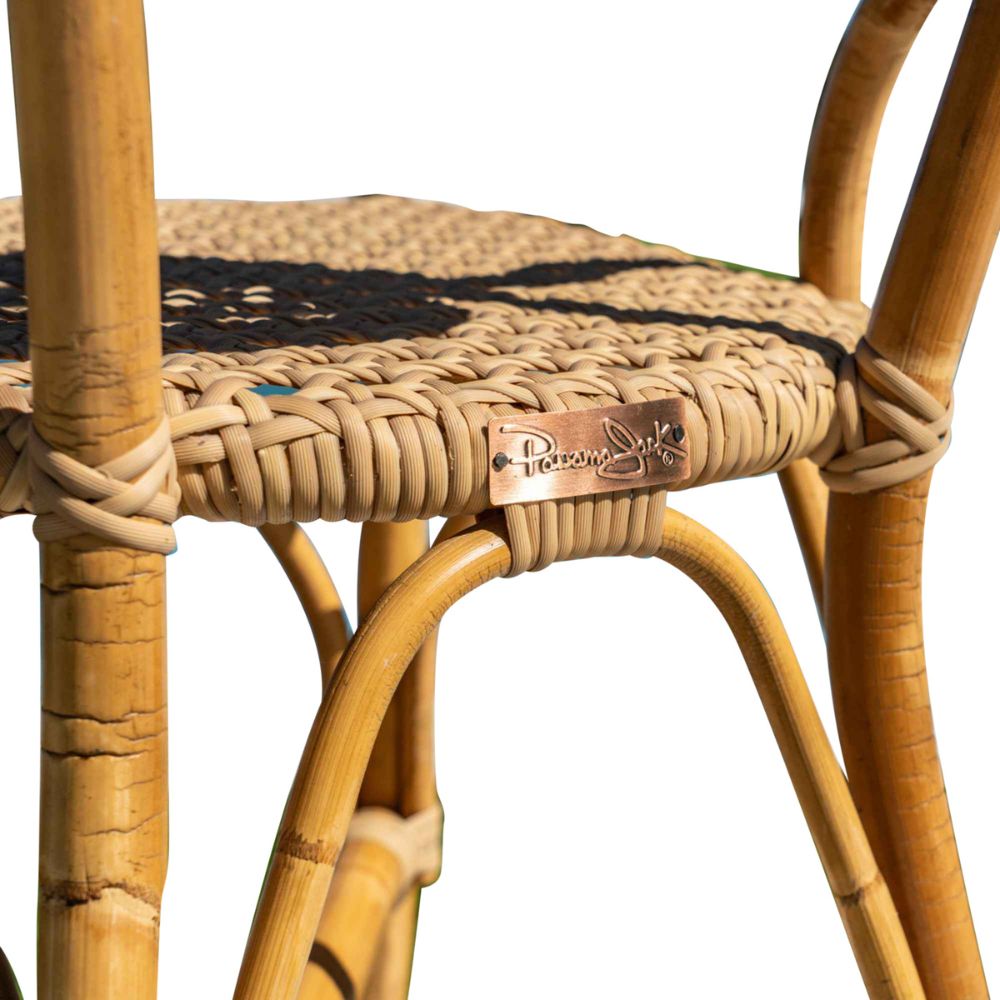 Close-up of a wicker chair with a brand tag on a white background
