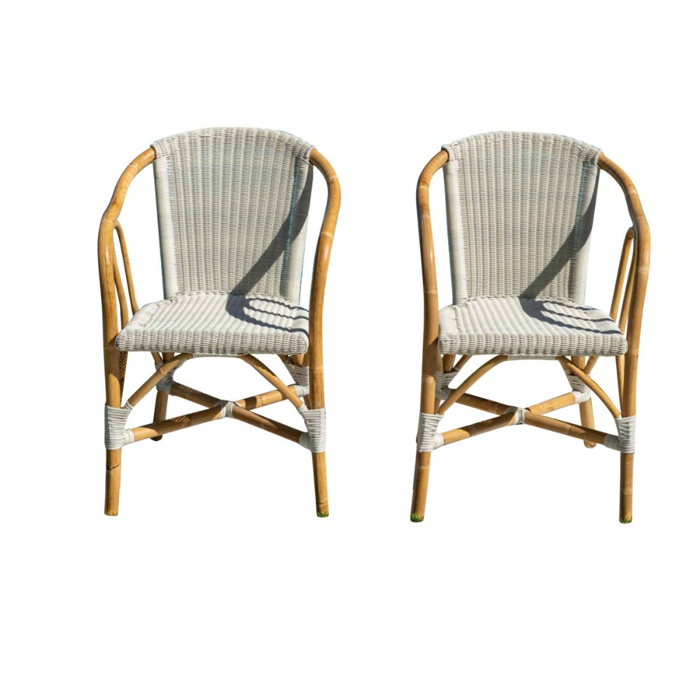 Two wicker chairs with striped cushions on a white background