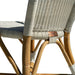 Close-up of a wicker chair with wooden legs on a white background