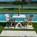 Outdoor dining table with chairs by a poolside